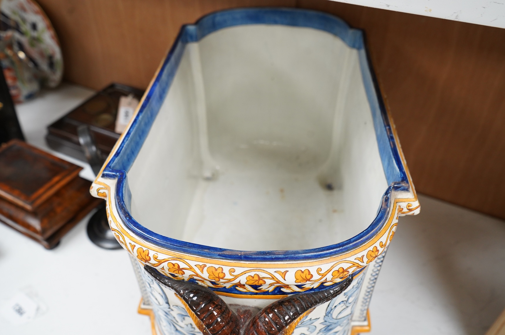 A large 19th century French faience wine cooler or planter with ram’s head handles, 60cm wide